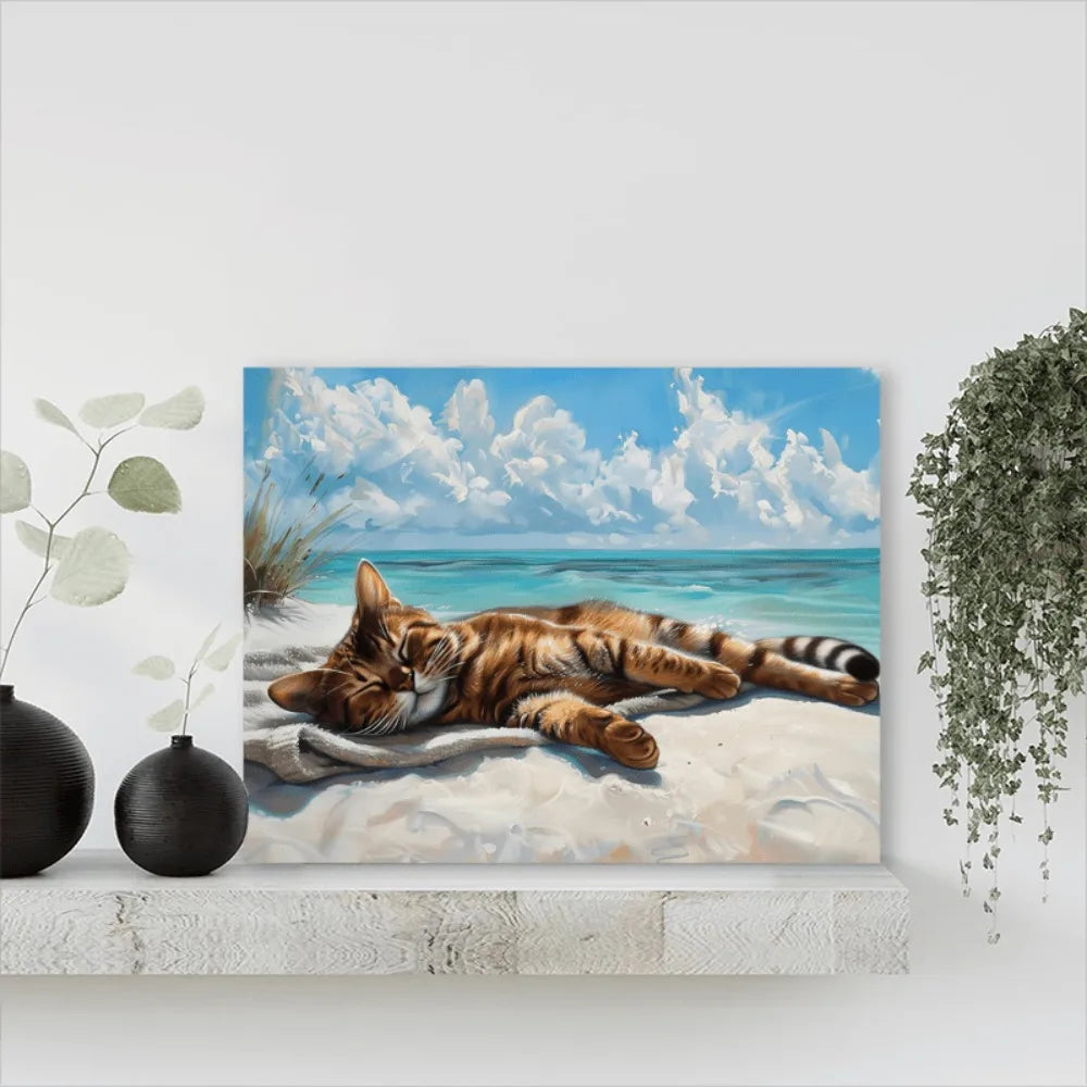 A coastal cat canvas wall art, a cat napping on the beach, wood-framed Marine theme.