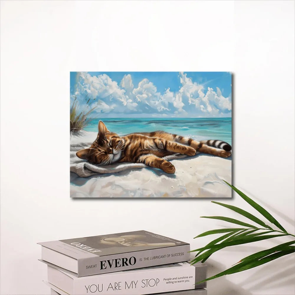 A coastal cat canvas wall art, a cat napping on the beach, wood-framed Marine theme.