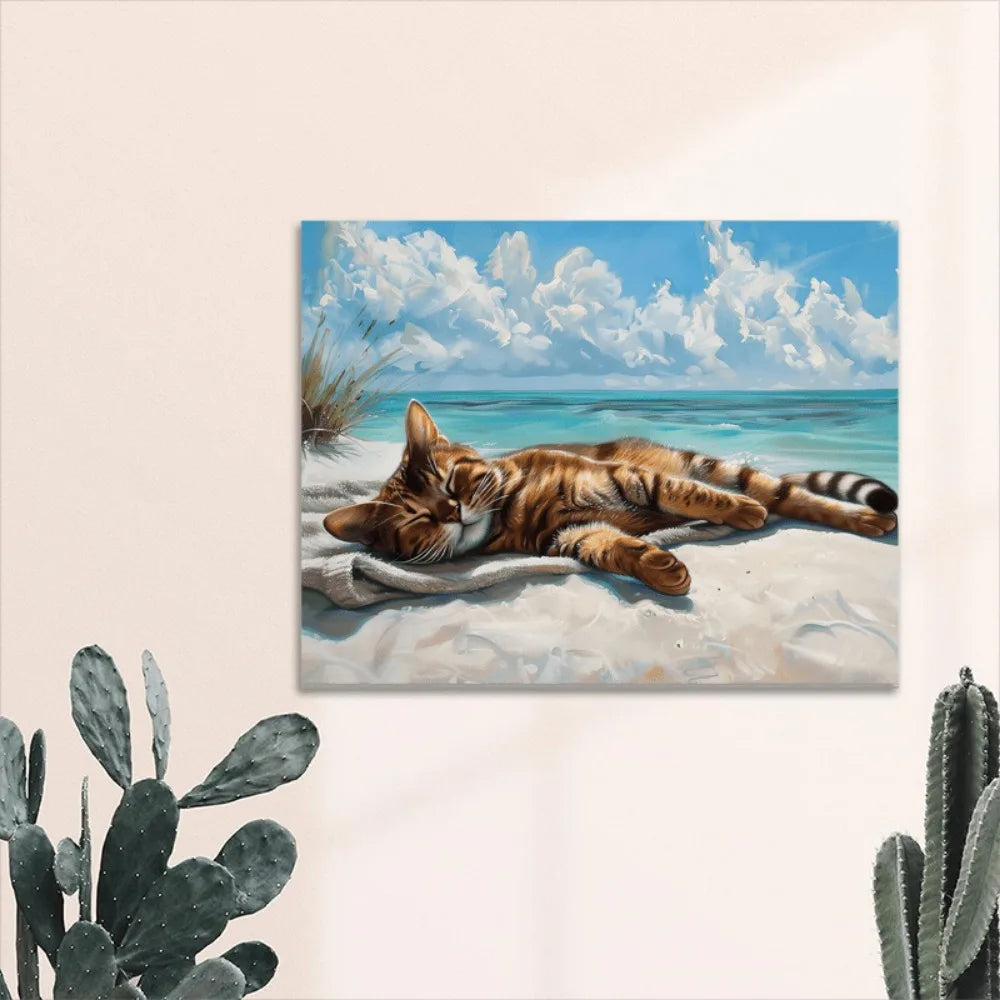 A coastal cat canvas wall art, a cat napping on the beach, wood-framed Marine theme.